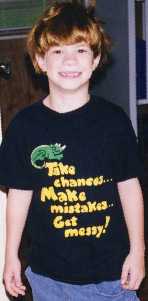black tee, with yellow letters, saying, Take chances! Make
mistakes! Get messy!